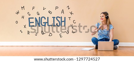 English with alphabets with young woman with headphones using a laptop computer and a pencil