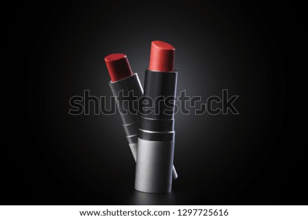 Lipstick on black background. Make-up concept.