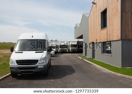 white truck and van in industrial environment near factory delivery distribution warehouse