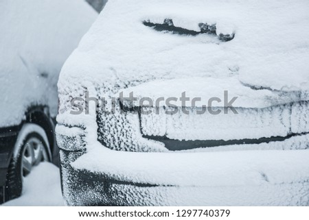 Back car covered with heavy snow. Calamity or blizzard concept.