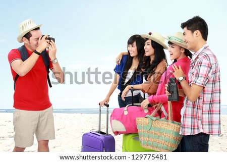 Young man take picture of his friends