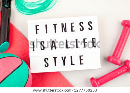 Flat lay of red dumbbell, sport equipments, fitness items, top view with copy space. Healthy lifestyle and weight loss concept