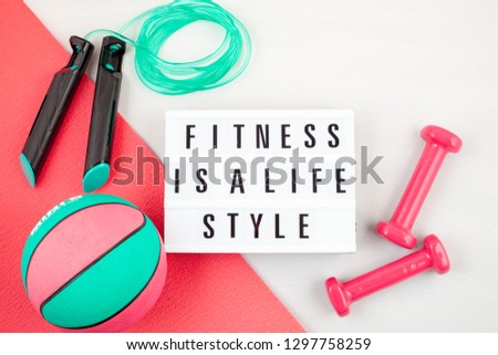 Flat lay of red dumbbell, sport equipments, fitness items, top view with copy space. Healthy lifestyle and weight loss concept