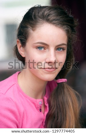 Beautiful teenage girl smiling at camera Royalty-Free Stock Photo #1297774405