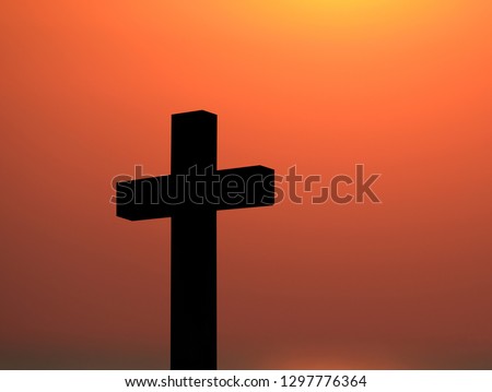 Cross and Crucifixion of Jesus Christ silhouette with fiery red  dramatic sky during  sunset. Religious symbolism, Mourning, memories and remembrance  from the one who you left behind. 