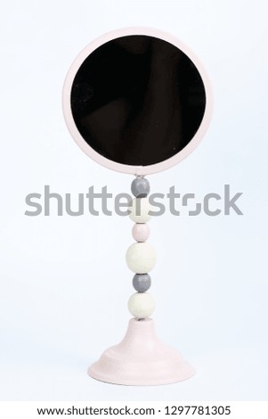 
small pink mirror on a white background