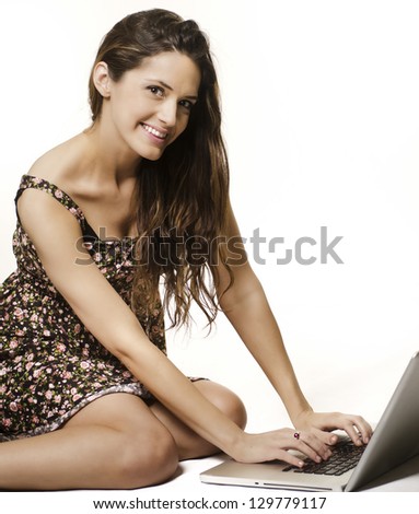 Young woman using laptop computer.  Isolated against white
