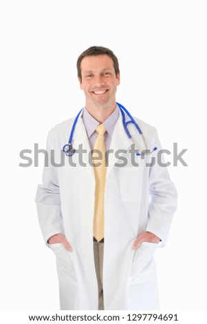 Cut out of smiling doctor wearing lab coat and stethoscope at camera