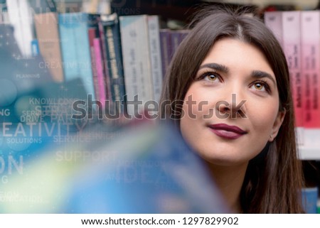 Beautiful adult female international student spending break at university library. searching for necessary literature lesson. Standing near bookshelves.