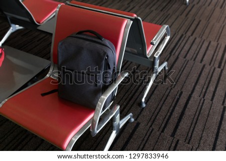 Small backpack on chairs at the airport