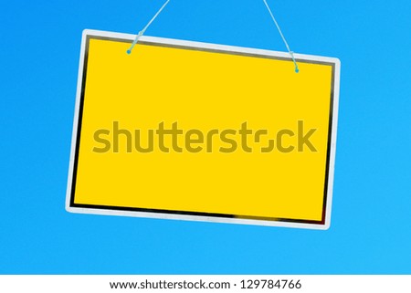 yellow sign hanging against a vibrant blue sky (copy-space available for design)