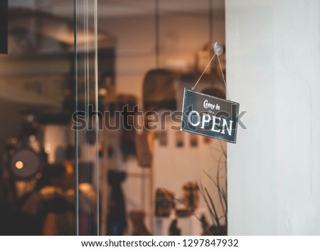 Sign is open on the store. Come in we're open sign
