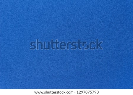 Macro abstract background view of frost or frozen ice texture with a blue hue on a glass window pane