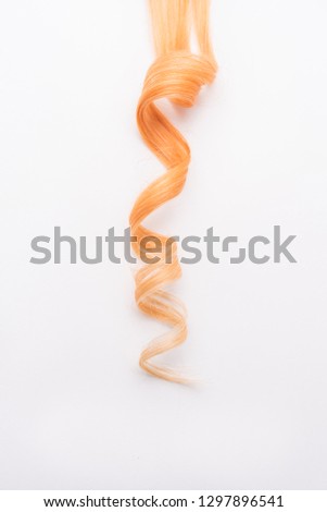 Human, natural honey-colored blond hair on white isolated background. Stylish, fashionable colors this year. Honey blonde curl or lock. An example of hairstyle. Royalty-Free Stock Photo #1297896541