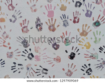 An abstract picture of a wall with hand or palm art.