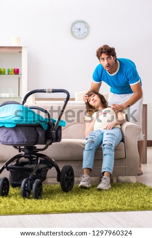 Young parents with baby expecting new arrival
