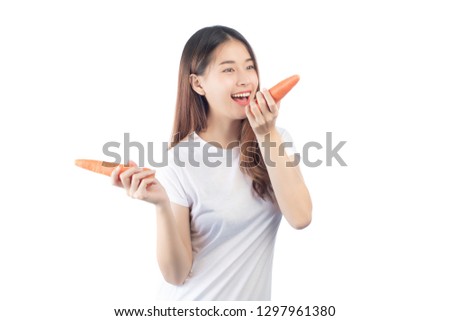 Beautiful woman asia with a happy smile holds a fresh carrot on hand, isolated on a white background.