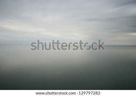 long time exposure of the ocean, soft water and cloudy sky Royalty-Free Stock Photo #129797282
