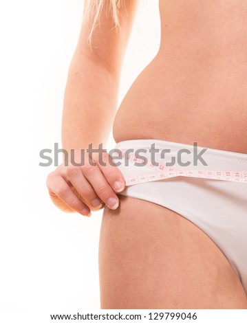 woman controling its waist hip with white measure tape