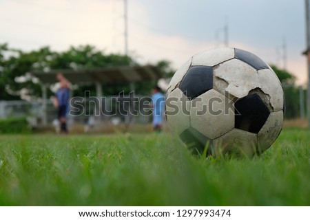 Old soccer ball on soccer field