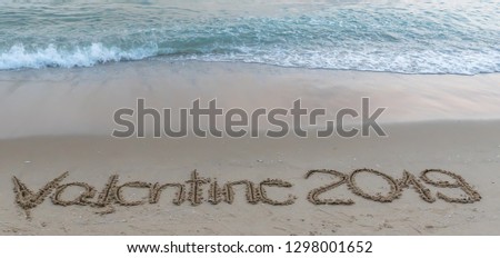 Valentine  2019  written  on  sandy  beach  background  at  sunset  time