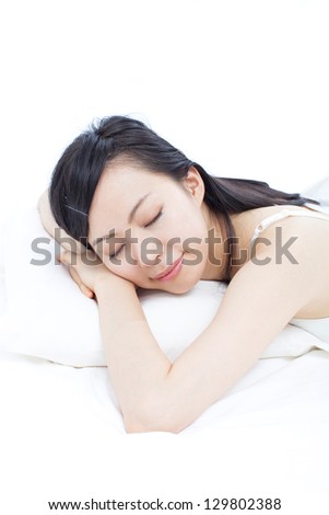beautiful young woman lying on the bad, isolated on white background