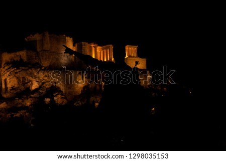 Nightshot photo of Acropolis, Athens, Greece. Silhouettes of tourists, visitors and locals at the Acropolis.