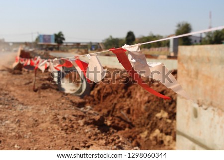 White and red flags hung on the road under construction