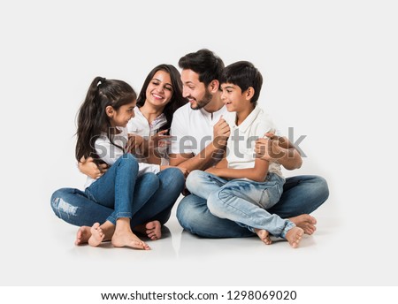 Young Indian/asian family sitting isolated over white background. selective focus