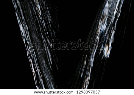 Water Splash On Black Background Falling raindrops footage animation in slow motion on dark black background with fog, lightened from top, rain animation with start and end, perfect for film, digital 