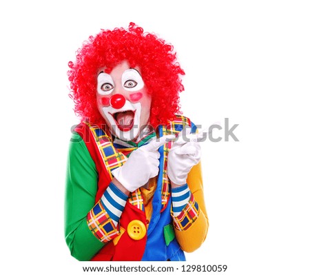 Happy clown pointing to the copy space area Royalty-Free Stock Photo #129810059