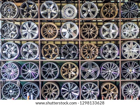Stand with alloy wheels in tire store 