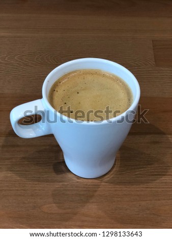 Coffee mug on wooden table.
