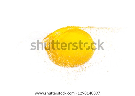 Whole lemon is thrown into the water and submerged.
