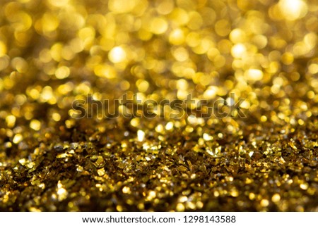 Gold glitter texture. Festive sparkling sequins background closeup.