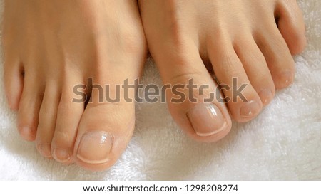 Photo of closeup woman feet and toes during foot massage on a white towel