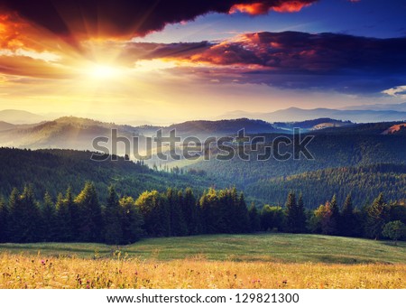Majestic sunset in the mountains landscape. Dramatic sky. Carpathian, Ukraine, Europe. Royalty-Free Stock Photo #129821300