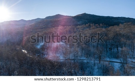 Aerial view of snow capped mountains during sunset. Location place Psebai, Russia.
