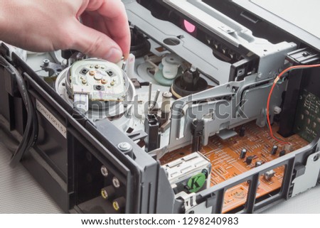Repair electronic device. Repair video player. Broken electronic video player.