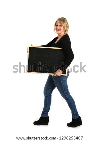 Portrait of a beautiful blonde middle aged woman holding a blackboard against a white background