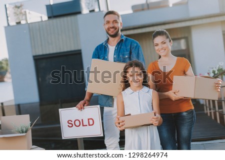 Joyful nice family having sold their house while getting ready for a removal