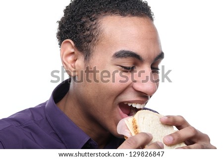 Beautiful teenager eating a sandwich