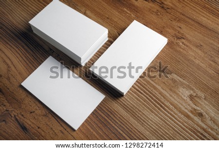 Photo of blank white business cards on wooden background. Template for ID.