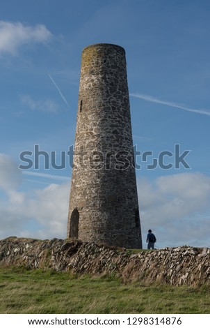 Male Hiker by the Daymark Navigation Tower on Stepper Point by Padstow on the South West Coast Path in Rural Cornwall, England, UK