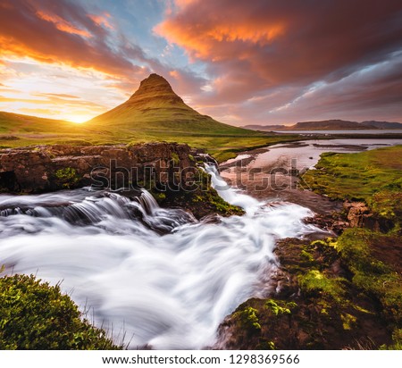 Gorgeous view of the awesome Kirkjufell volcano at sunset. Location place Kirkjufellsfoss waterfall, Iceland, Europe. Scenic image of most popular tourist attraction. Explore the beauty of earth.