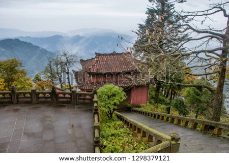 The traditional architecture of Buddhism Temple in EmeiShan National Park. The rainy and foggy day in the autumn mountain forest.  Sichuan province, China.