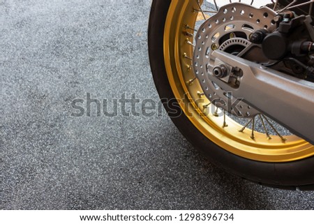 closeup tire and dish bake of sport motorcycle ( big bike ) with soft-focus and over light in the background