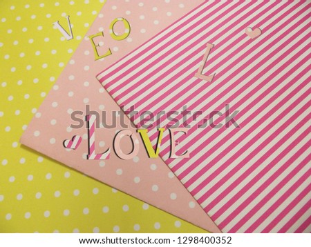 Love text cut out from wrapping paper.