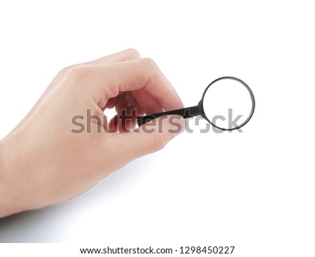 close up. magnifying glass in hand businessman.photo with copy space
