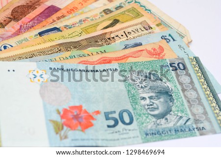 Mixed World Currency from around the globe over white background.